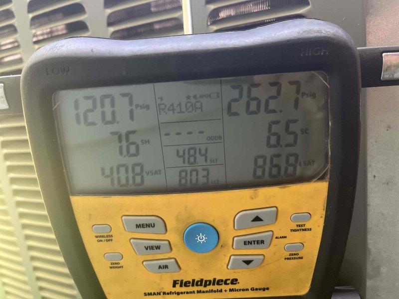 Returned to complete leak search on HVAC system after customer reported diminished cooling performance and suspected refrigerant loss. Utilized digital manifold gauges to measure system pressures and temperatures, recording superheat at 76°F and subcooling at 6.5°F, with operating pressures of 120.7 psig on low side and 262.7 psig on high side. Performed comprehensive leak detection procedures using previously injected UV dye and clamp meter diagnostics to identify potential leak location that was flagged during previous visit.