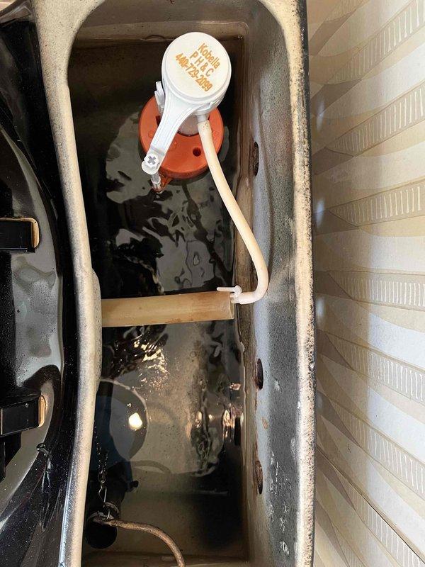 Responded to service call for toilet backing up. Upon inspection, discovered issue was related to HVAC condensate drain system rather than plumbing drain line. Found condensate drain pan severely clogged with sediment, biological growth, and debris causing water backup. Cleared accumulated sludge from drain pan, cleaned float switch assembly, and verified proper drainage function. System tested and operating correctly upon completion.