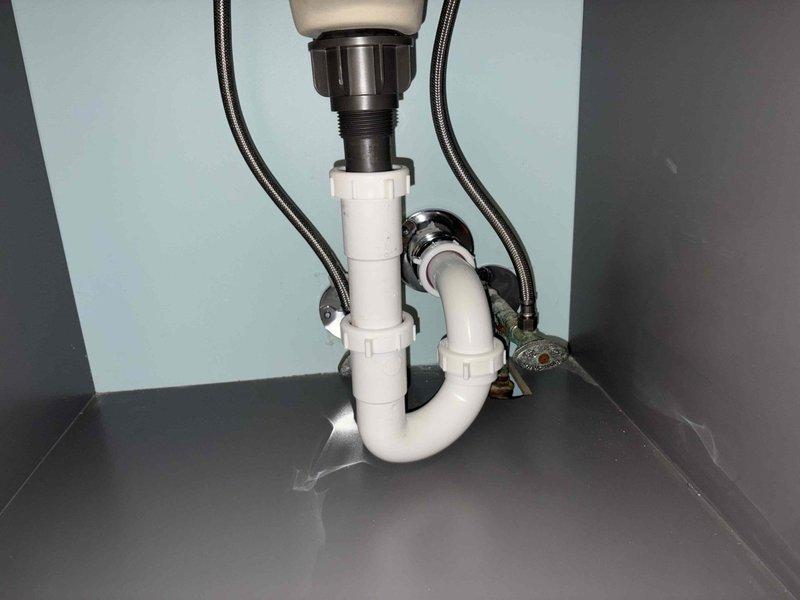 Returned to complete kitchen plumbing installation previously sold, including basket strainer replacement, drain tubular assembly, and hose bib installation. Successfully installed new kitchen sink basket strainer with proper sealing, replaced P-trap and drain tubular components under sink with white PVC piping, and ensured all connections were secure and leak-free. All plumbing fixtures tested and verified operational upon completion.
