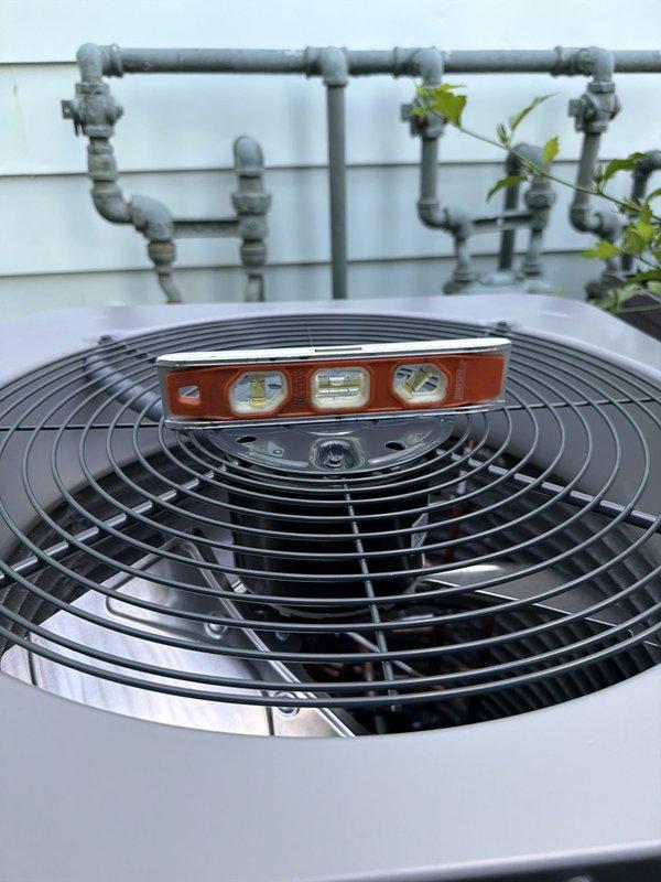 Completed installation of new air conditioning system with evaporator coil as previously approved. Unit was properly leveled and positioned on DiversiTech equipment pad against exterior wall with refrigerant line set and drainage piping configured and secured. Modified filter access arrangement to improve accessibility for homeowner and provided additional 16x25x1 filter for future use.