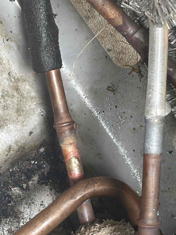 Returned to site to address factory defect in condenser unit. Brazed shut leak in condenser coil, removed failed filter drier and brazed in new replacement. Performed complete pressure test to verify system integrity and confirm no additional leaks present. Evacuated system to proper vacuum levels and recharged unit with refrigerant to manufacturer specifications. All warranty work completed and system returned to full operational status.