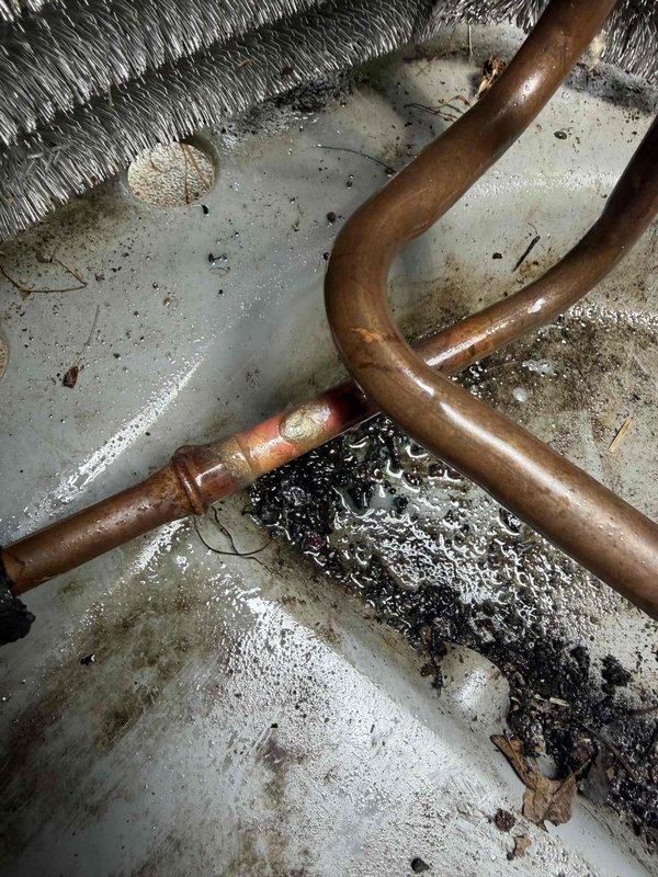 Returned to site to address factory defect in condenser unit. Brazed shut leak in condenser coil, removed failed filter drier and brazed in new replacement. Performed complete pressure test to verify system integrity and confirm no additional leaks present. Evacuated system to proper vacuum levels and recharged unit with refrigerant to manufacturer specifications. All warranty work completed and system returned to full operational status.