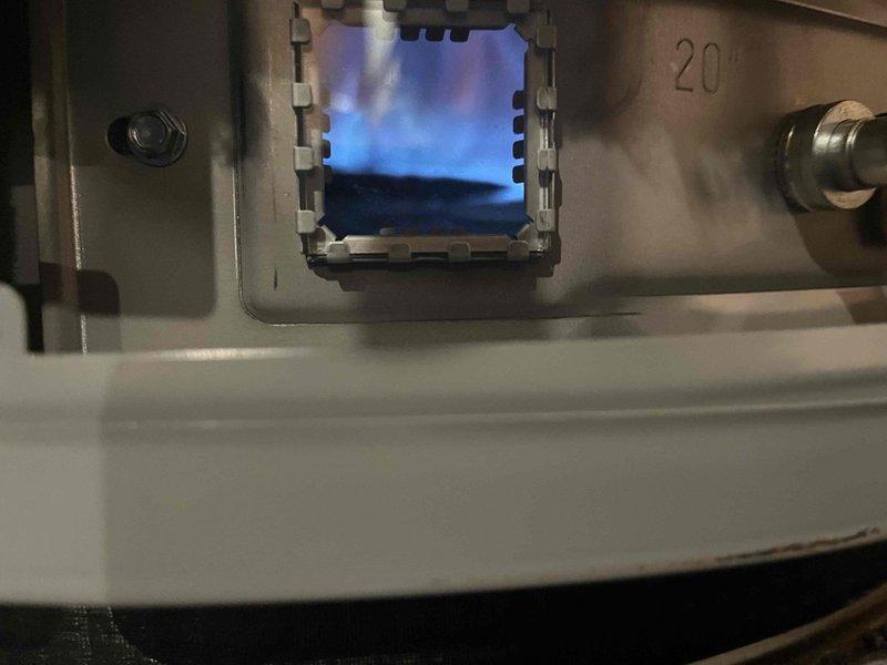 Completed annual maintenance on a 50-gallon lowboy natural gas water heater. Inspected burner assembly and confirmed proper combustion with visible blue flame through viewing port, indicating efficient gas-to-air mixture. Verified all plumbing connections, copper piping, shut-off valves, and associated equipment including water treatment system and expansion tank for proper operation and no visible leaks.