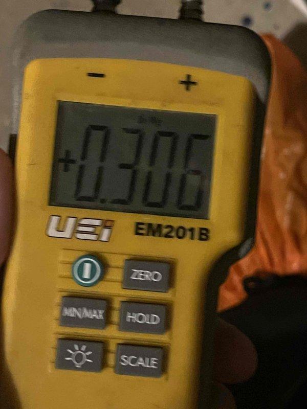 Completed prepaid cooling maintenance club visit. Performed system diagnostics using digital manometer, recording pressure readings of +0.706 to verify proper refrigerant charge and airflow. Inspected water heater drain valve, noting mineral buildup and sediment accumulation inside valve assembly that may require future service attention.