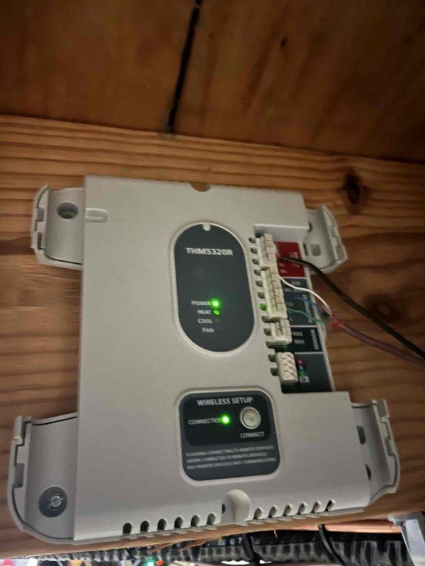 Responded to callback for mini split system that would not turn off after initial startup. Inspected THMS320R zone control module and associated HVAC control board. Verified proper wiring connections at terminal blocks and confirmed wireless connectivity status showing green "CONNECTED" indicator. Reviewed system configuration on control board LCD display showing air handler setup with zone controls and purge time settings. Diagnosed and resolved issue preventing system from responding to shutdown commands, restoring normal on/off operation functionality.