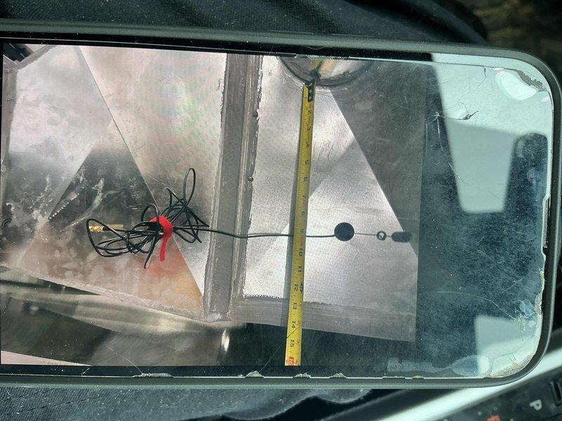 Completed warranty service call for thermostat issue. Accessed air handler unit and documented interior ductwork measurements using measuring tape to verify proper clearances and component positioning. Inspected reflective insulation liner condition within ductwork system and confirmed wiring connections were secure with proper wire management in place.