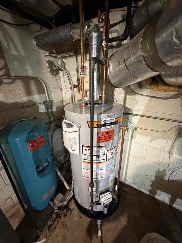 Removed existing Kinetico water softener system and completed installation of new iron filter and 40-gallon gas short water heater. All plumbing connections were made with copper piping, including proper hot and cold water lines with shutoff valves, temperature and pressure relief valve, and gas line connection. Blue pressure tank was positioned and connected to the filtration system. All units were properly vented, tested for leaks, and confirmed operational.