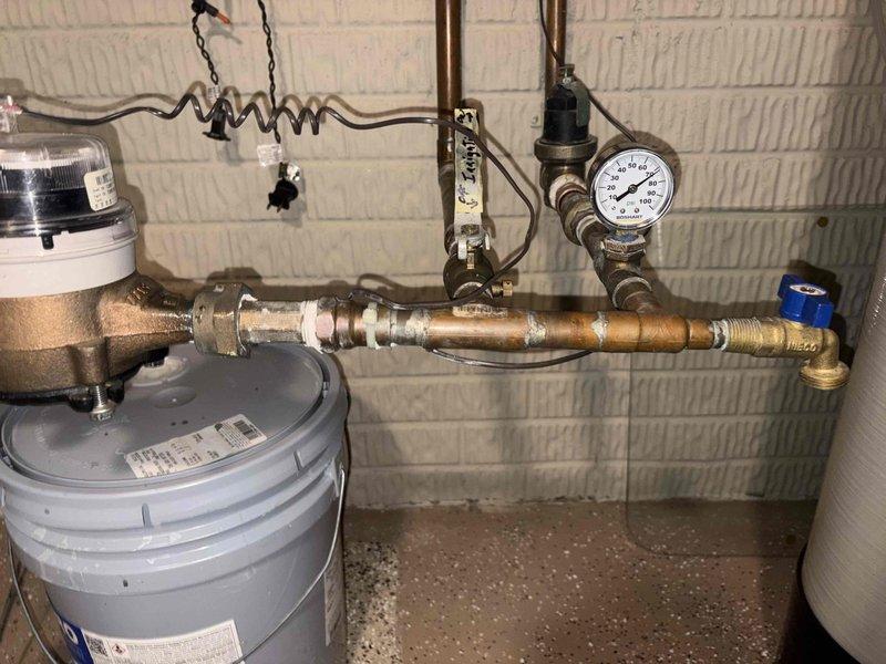Performed routine club maintenance visit and inspected tankless water heater system. Flushed tankless water heater to remove sediment buildup and mineral deposits, as evidenced by heavily contaminated filter screen removed during service. Inspected water supply piping, pressure regulator, and pressure gauge; noted age-related tarnishing and surface corrosion on brass components but system remains functional. Advised customer of club membership renewal requirement for continued maintenance coverage.