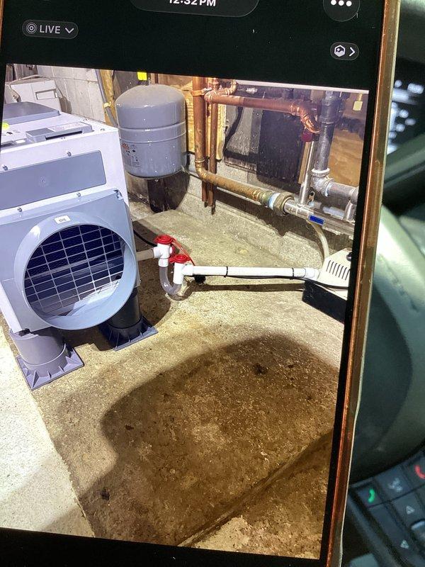 Completed installation of whole home dehumidifier in basement mechanical room. Unit was positioned on rubber mounting pad adjacent to existing HVAC equipment and integrated into the home's ductwork system. All electrical connections, condensate drainage, and refrigerant lines were properly installed and tested for optimal operation.