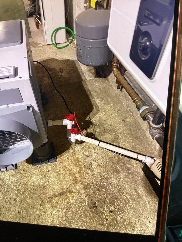 Completed installation of whole home dehumidifier in basement mechanical room. Unit was positioned on rubber mounting pad adjacent to existing HVAC equipment and integrated into the home's ductwork system. All electrical connections, condensate drainage, and refrigerant lines were properly installed and tested for optimal operation.