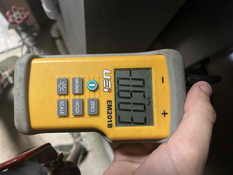 Returned to property to perform system airflow balance as previously sold. Utilized digital manometer (UEI EM201B) to measure static pressure readings in inches of water gauge before the coil and at additional test points throughout the HVAC system. Adjusted airflow parameters to achieve proper system balance and optimal performance. Documentation photos captured of pressure measurements during balancing procedure.
