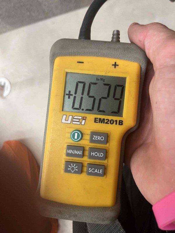 Responded to service call for second opinion on no-cooling complaint with frozen refrigerant line. Upon arrival, performed diagnostic evaluation of Bryant Plus 90t system. Conducted static pressure testing using digital manometer, obtaining reading of +0.529 inches water column to assess airflow across evaporator coil. Determined frozen line condition was likely caused by restricted airflow rather than low refrigerant charge as previously suspected. Recommended allowing system to thaw completely and addressing potential airflow restrictions including dirty air filter, blocked return air pathways, or blower motor issues before proceeding with refrigerant testing.