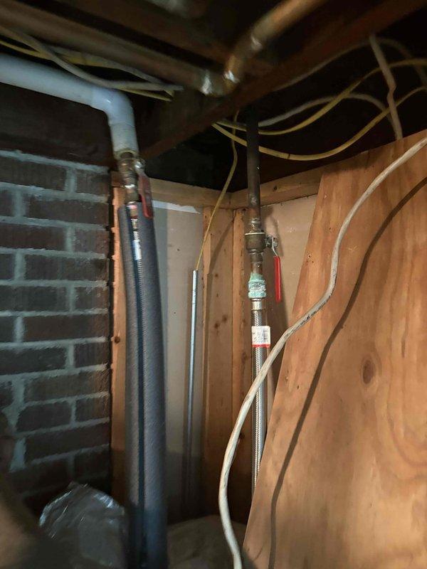 Performed assessment of existing boiler system in residential basement following homeowner concerns about inadequate heating capacity after home addition was completed. Evaluated boiler sizing relative to current heating load requirements, documented existing equipment configuration including water heater and distribution piping, and photographed mechanical room layout to support replacement estimate for properly sized heating system.