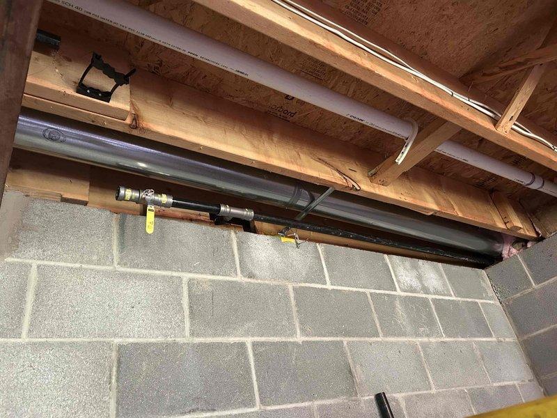 Returned to property to address gas line installation follow-up and conduct safety verification. Reviewed original floor plan documentation showing gas line routing through building structure relative to exterior walls. Inspected installed gas piping system in basement area, including copper supply lines with brass fittings and valves, ensuring proper installation clearances from drain lines and structural joists. Performed comprehensive leak detection and safety testing using multi-gas detector to verify system integrity and compliance with code requirements. All connections tested and verified secure with no leaks detected.
