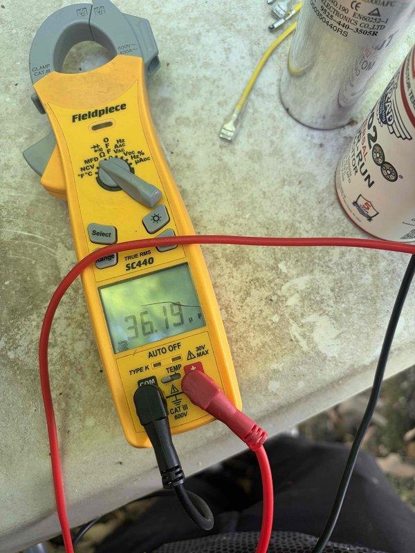 Responded to no cooling call on 2008 Trane air conditioning system. Upon arrival, performed diagnostic testing on outdoor unit using clamp meter and found failed dual-run capacitor with zero amperage reading to compressor. Replaced defective capacitor with new dual-run unit, verified proper electrical connections, and confirmed compressor amperage at 36.79A within manufacturer specifications. System tested and restored to normal cooling operation.