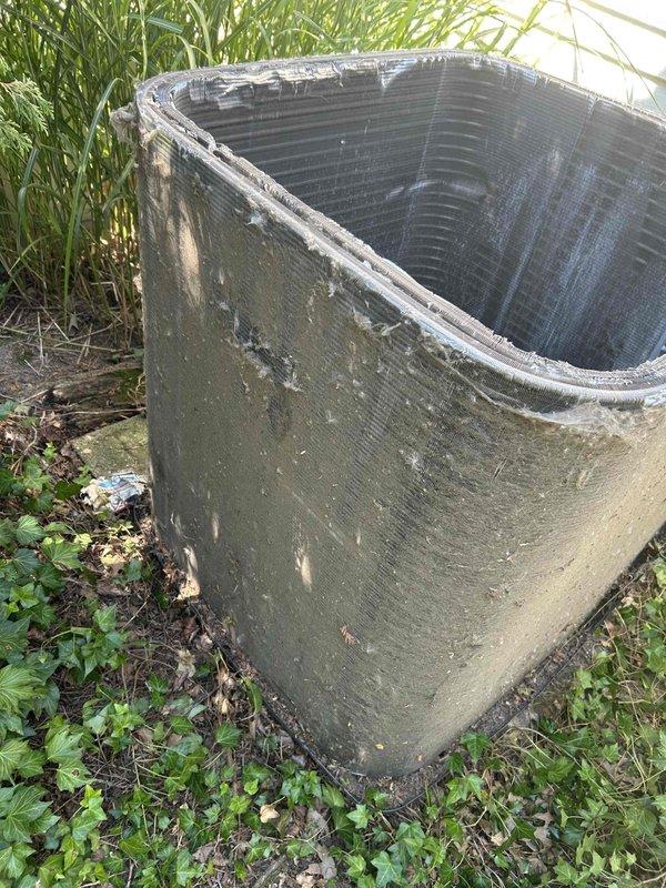 Returned to property to complete previously sold repair work on outdoor condensing unit. Upon arrival, found unit heavily soiled with accumulated dirt, debris, algae growth, and biological matter covering exterior surfaces and coil fins. Performed thorough cleaning of condenser cabinet, removing organic buildup, moss, and environmental contamination from all exterior panels. Cleaned condenser coil to restore proper airflow and heat transfer efficiency. Cleared vegetation and debris from around unit perimeter to ensure adequate clearance for proper operation and serviceability. Verified unit operational following cleaning procedures.