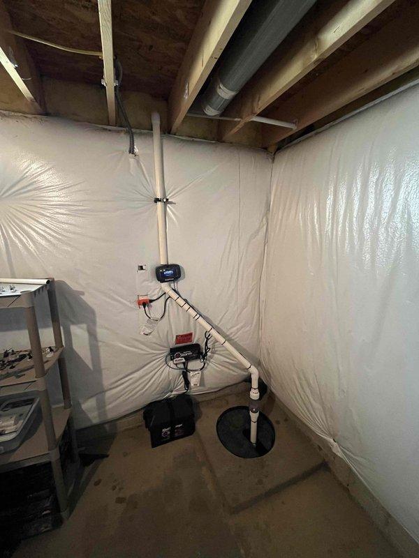 Completed installation of new primary sump pump and battery backup system in basement sump pit. Installed new pump with PVC discharge piping, check valve, and proper connections to ensure reliable water removal and flood protection during power outages.