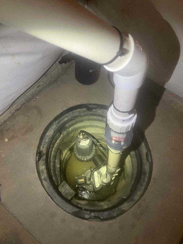 Completed installation of new primary sump pump and battery backup system in basement sump pit. Installed new pump with PVC discharge piping, check valve, and proper connections to ensure reliable water removal and flood protection during power outages.