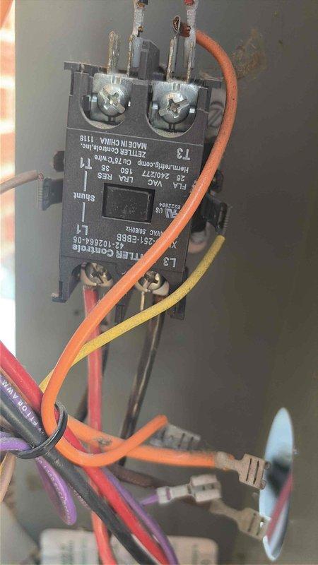 Responded to no cooling complaint with indoor air handler operating but outdoor unit fan not running. Upon inspection, found failed dual run capacitor with severely corroded terminals and rust damage. Removed defective capacitor and installed new replacement unit. Tested contactor operation and verified all electrical connections secure. System restored to normal operation with outdoor condenser fan and compressor running properly.