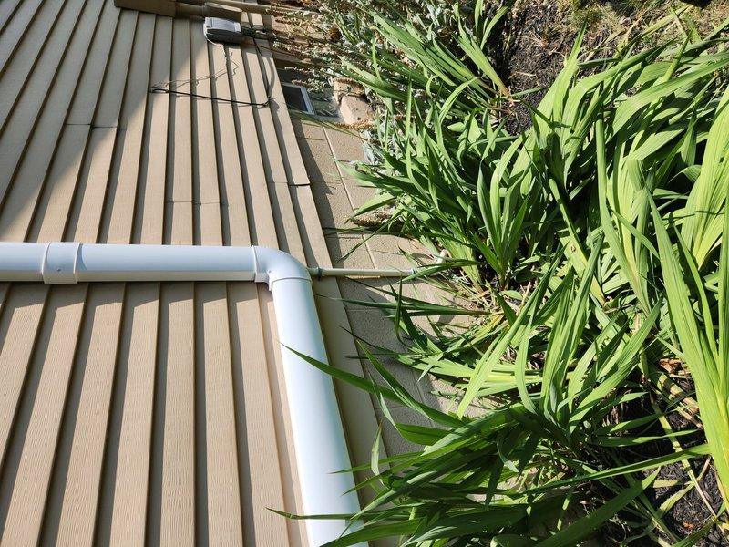 Extended HVAC condensate drain lines to terminate several inches above ground level as required. Installed approximately 40 feet of PVC piping with appropriate fittings and secured all sections with proper strapping to deck structure and building exterior. Drain lines now properly discharge away from foundation with adequate clearance from ground surface to prevent blockage and ensure proper drainage function.