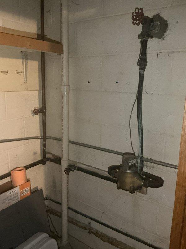 Conducted comprehensive inspection of legacy plumbing system in 1985-built home, focusing on obsolete well water piping infrastructure located in basement utility areas. Evaluated condition of aged copper supply lines, hydronic heating components including circulator pump assemblies, gate valves with decorative wheel handles, pressure gauges, and associated pipe configurations across multiple wall-mounted runs. Assessed visible corrosion, oxidation patterns, and overall integrity of existing copper piping showing typical age-related deterioration. Documented plumbing closet locations and existing pipe routing to advise on removal or modernization options in conjunction with planned remodel of older room. Provided homeowner with professional recommendations for updating antiquated plumbing infrastructure, including options for abandoning unused well water supply lines, consolidating pipe runs, and eliminating unnecessary fixtures to optimize space utilization during renovation project.