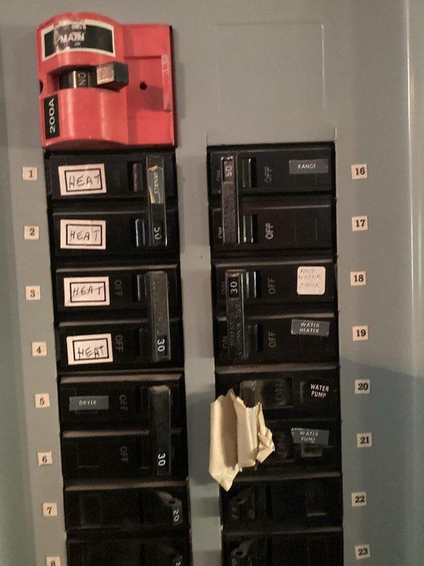 Conducted site assessment for complete HVAC system replacement at residential property. Existing system installed in 2008 with no current operational issues reported. Documented electrical infrastructure including main breaker panel configuration, circuit allocations for heating system, and existing electrical capacity to determine compatibility requirements for new equipment installation. Photographed circuit breaker panel showing dedicated heating circuits on positions 1-4, along with other major appliance circuits including dryer, range, water heater, and water pump. Reviewed panel wiring diagram and circuit directory to assess electrical specifications and available capacity for proposed HVAC system upgrade. Assessment completed to provide accurate equipment sizing recommendations and installation quote for eighteen-year-old system replacement.