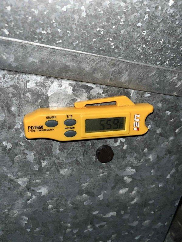 Completed scheduled cooling maintenance for club member's air handler system. Performed comprehensive inspection of condensate drain assembly, including safety float switch and PVC piping connections. Verified proper operation of overflow protection device with red safety switch mechanism. Checked condensate drain lines and black corrugated drain hose for blockages and proper flow. Measured supply air temperature at 55.9°F using calibrated digital thermometer, confirming adequate cooling performance. All components operating within normal parameters. System running efficiently with no issues identified.