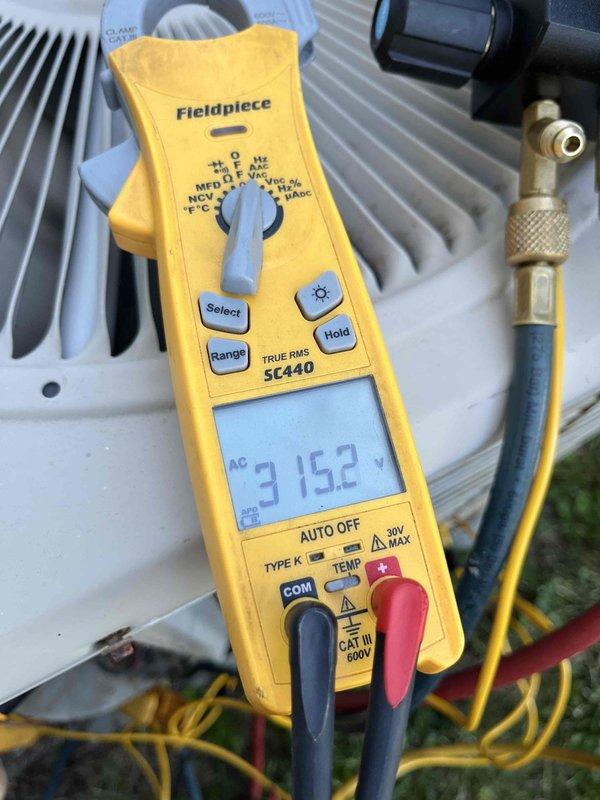 Completed comprehensive air conditioning tune-up on aging residential system. Performed electrical diagnostics using clamp meter, recording amperage draw of 315.2A on compressor circuit. Inspected outdoor condenser unit, verified coil cleanliness and fin condition, checked refrigerant connections and service valves for integrity. Noted minor corrosion on electrical junction box and contactors, typical of outdoor equipment exposure. All components operating within acceptable parameters at time of service.