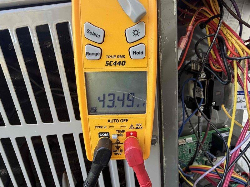 Completed scheduled cooling maintenance member visit on HVAC system. Performed electrical diagnostics using digital multimeter, measuring voltage at 43.49V at control panel and verifying amperage draw at 8.59A with 0.7V secondary reading. Inspected wiring connections, circuit breakers, and control board components within equipment cabinet to ensure proper system operation and safety compliance.