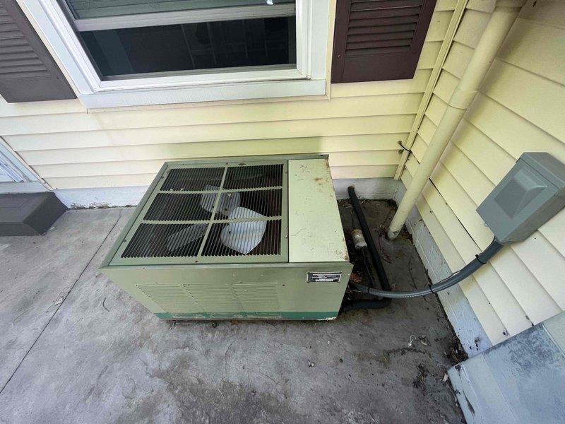 Responded to no cooling call at residential property. Upon arrival, found outdoor condensing unit inoperative. Inspection revealed system low on refrigerant due to failed capacitor causing compressor failure to start. Replaced defective dual run capacitor with proper rated component. Tested system operation, verified proper amperage draw, and confirmed adequate airflow through condenser coil. System restored to normal cooling operation with all safety controls functioning properly.