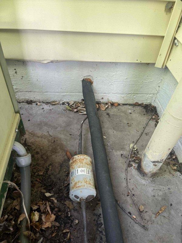 Responded to no cooling call at residential property. Upon arrival, found outdoor condensing unit inoperative. Inspection revealed system low on refrigerant due to failed capacitor causing compressor failure to start. Replaced defective dual run capacitor with proper rated component. Tested system operation, verified proper amperage draw, and confirmed adequate airflow through condenser coil. System restored to normal cooling operation with all safety controls functioning properly.