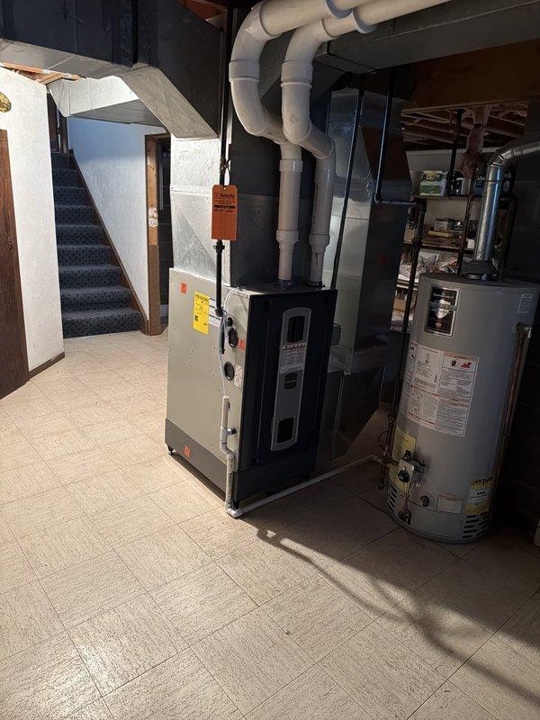 Completed full HVAC system installation in basement utility area, including new air handler unit and associated ductwork with white PVC ventilation piping routed along ceiling joists. Verified proper equipment leveling and ensured all mechanical connections, condensate drainage, and system components were properly installed and secured per manufacturer specifications.