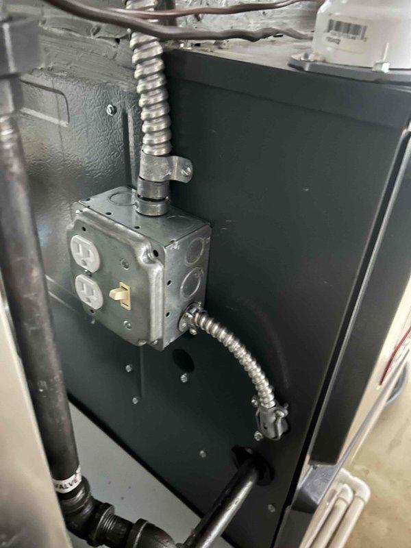# HVAC Service Report

Responded to emergency no-cooling call on eight-year-old residential air conditioning system. Upon arrival, performed visual inspection of outdoor condensing unit and verified proper airflow through intake and exhaust vents. Inspected electrical connections at junction box, confirmed secure conduit connections and proper power supply to unit. Verified all mechanical components accessible during exterior inspection were properly mounted and operational. Documented equipment condition with photographic evidence showing intake/exhaust vent assembly with unobstructed airflow passages and electrical junction box with dual outlets and metallic conduit connections in good working order.