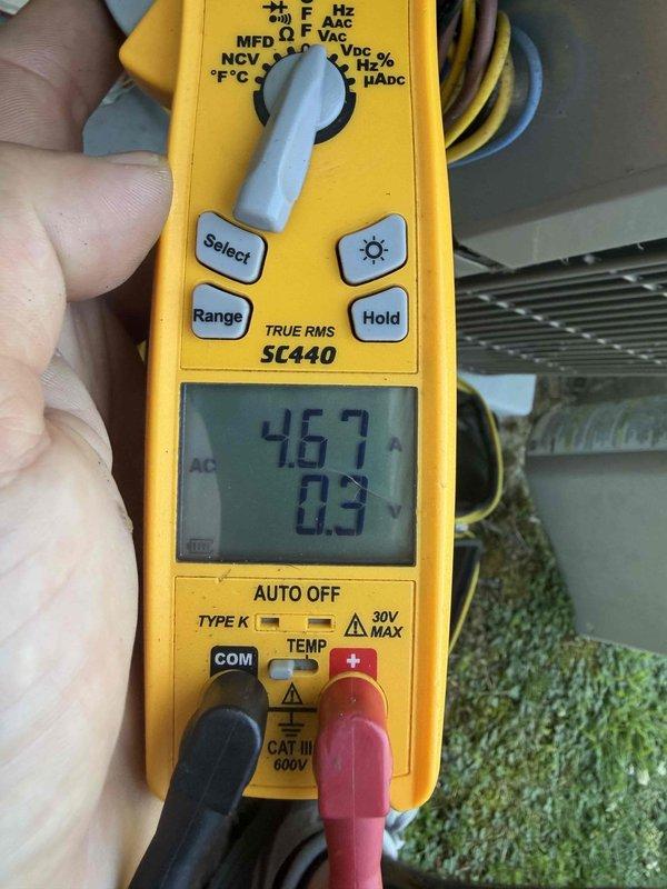 Completed cooling maintenance club visit on residential HVAC system. Performed comprehensive system diagnostics including electrical measurements, recording 467V AC current draw and 0.3A operating amperage using digital clamp meter. Inspected control panel which displayed under voltage condition at 121V, indicating potential power supply issue requiring monitoring. Documented equipment conditions with photos showing outdoor condensing unit components, electrical connections, and control interface readings. System operational at time of departure with voltage anomaly noted for future reference.