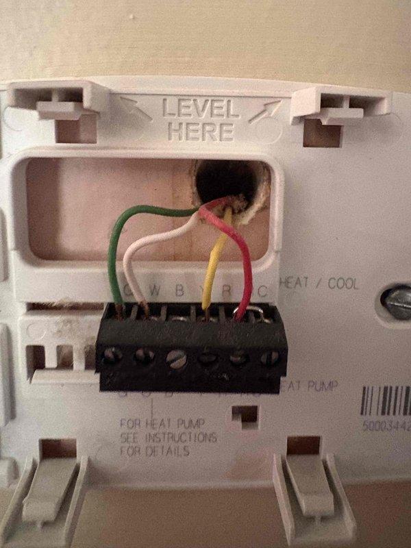 Conducted comprehensive site assessment for HVAC system replacement estimate. Documented existing electrical infrastructure including main distribution panel with Square D circuit breakers and residential thermostat wiring configuration showing standard four-wire setup (R, Y, W, G terminals). Gathered information regarding current heating and cooling system type, age, operational status, and confirmed presence of multiple units to determine appropriate replacement specifications and electrical requirements for new equipment installation.