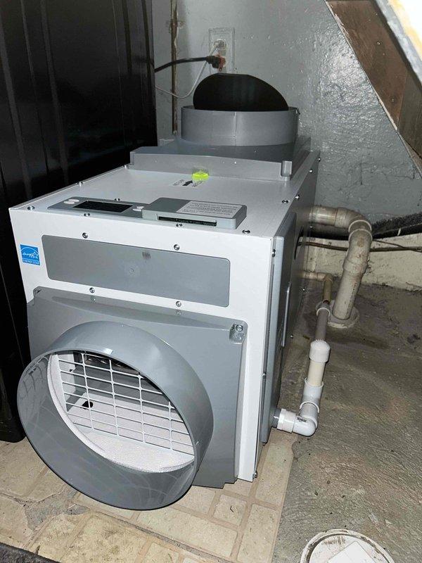 Responded to service call for noisy outdoor central air conditioning unit. Upon inspection and diagnostics, recommended and sold a new dehumidifier unit to address humidity control issues in the basement mechanical room. Installed Energy Star rated dehumidifier with proper drainage connections to existing PVC plumbing system and connected flexible ductwork to wall exhaust. Configured control panel settings and verified proper operation of all internal components and circuitry. Unit is now operational and functioning as designed.