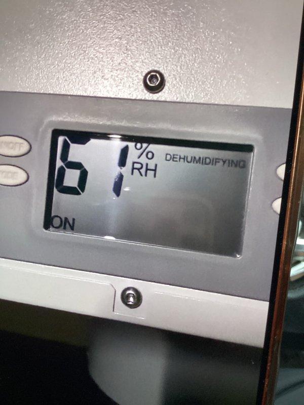Responded to callback for newly installed dehumidifier displaying E5 error code (high temperature thermistor fault at compressor outlet). Performed power cycle of unit and conducted diagnostic troubleshooting of thermistor circuit and compressor discharge temperature sensor. Verified unit returned to normal operation, displaying 67% RH and actively dehumidifying. Documented equipment status with photos showing control interface in OFF mode and unit successfully running in dehumidifying cycle.