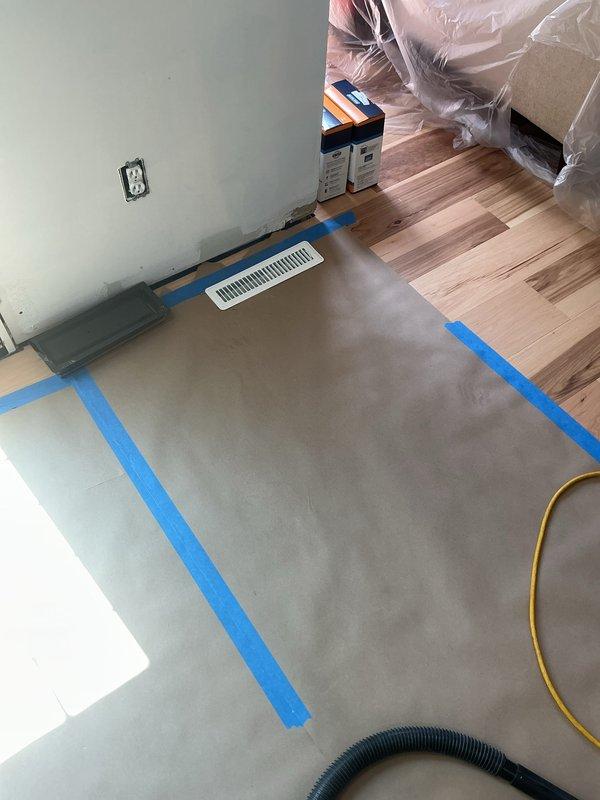 Completed ductwork installation in residential property with access through rear entrance. Installed new floor register and ductwork routing in room undergoing flooring renovation, coordinating work around active construction. All ductwork properly secured and venting operational upon completion.