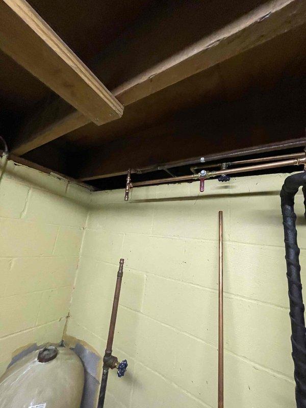 Responded to basement water intrusion concern following previous service visit. Conducted thorough inspection of basement plumbing system, including copper supply lines, valve connections, and water heater installation. No active leaks or moisture sources identified during visual examination of exposed piping, fixtures, and surrounding wall surfaces at time of inspection.