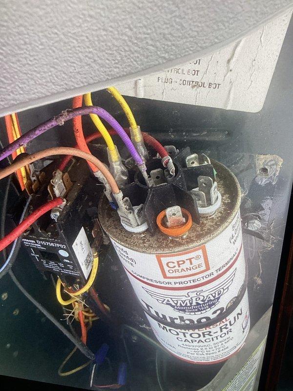Completed routine cooling maintenance member visit on HVAC system. Inspected and photographed electrical control panel components including compressor protection capacitor with proper wire connections and relay module. Performed electrical diagnostics using clamp meter to verify system performance and operational parameters.