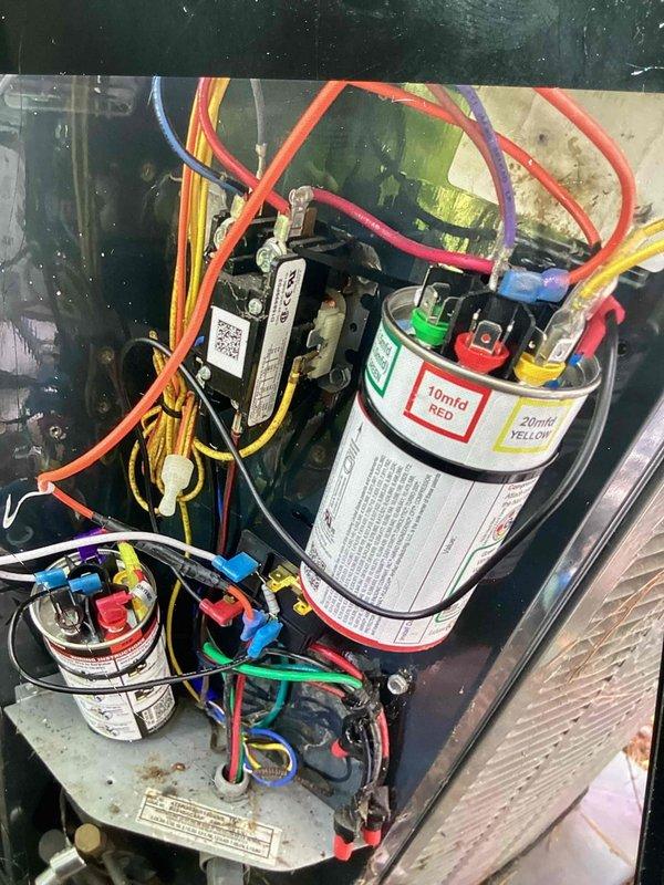 Replaced failed dual run capacitor and installed hard start kit on HVAC system to restore proper compressor operation. Performed complete system tune-up including electrical testing, which confirmed proper voltage and amperage readings at 6.05 on multimeter. All wiring connections secured and system returned to normal operating condition.