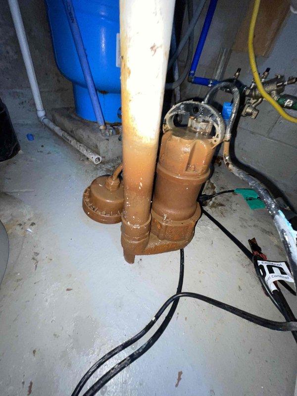 Responded to service call for malfunctioning sump pump installed two years prior that was humming but not pumping, with water accumulating in the basin. Upon inspection, determined pump motor was running but impeller was not moving water, indicating mechanical failure or obstruction. Replaced defective sump pump unit with new submersible pump, reconnected discharge piping to existing vertical PVC system, and tested operation to ensure proper water evacuation from sump crock. Verified check valve function, confirmed pump cycling correctly with float switch activation, and ensured system was fully operational prior to forecasted rainfall.