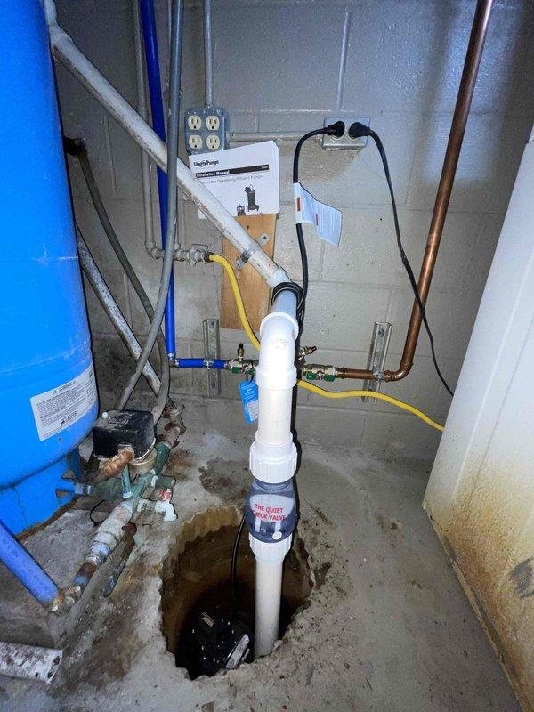 Responded to service call for malfunctioning sump pump installed two years prior that was humming but not pumping, with water accumulating in the basin. Upon inspection, determined pump motor was running but impeller was not moving water, indicating mechanical failure or obstruction. Replaced defective sump pump unit with new submersible pump, reconnected discharge piping to existing vertical PVC system, and tested operation to ensure proper water evacuation from sump crock. Verified check valve function, confirmed pump cycling correctly with float switch activation, and ensured system was fully operational prior to forecasted rainfall.