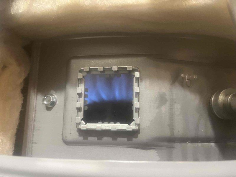 Completed installation of State brand tanked water heater with proper leveling and secure plumbing connections. Connected copper supply lines with brass fittings and installed pressure relief valve with appropriate discharge piping, verified unit was level and stable, then tested burner assembly for proper ignition and flame pattern to ensure safe operation.