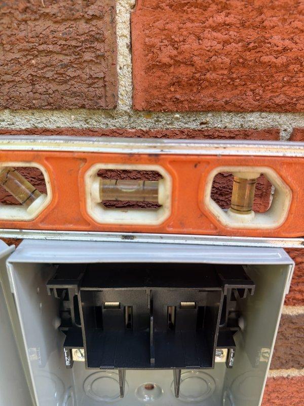 Completed air conditioning system installation as a return visit for AC-only equipment. Installed new dual fuse holder assembly with TR20R rated fuses and verified proper electrical connections with appropriate gauge wiring. Mounted outdoor disconnect box on exterior brick wall, ensuring level installation and proper clearances per code requirements. All electrical components tested and verified operational.