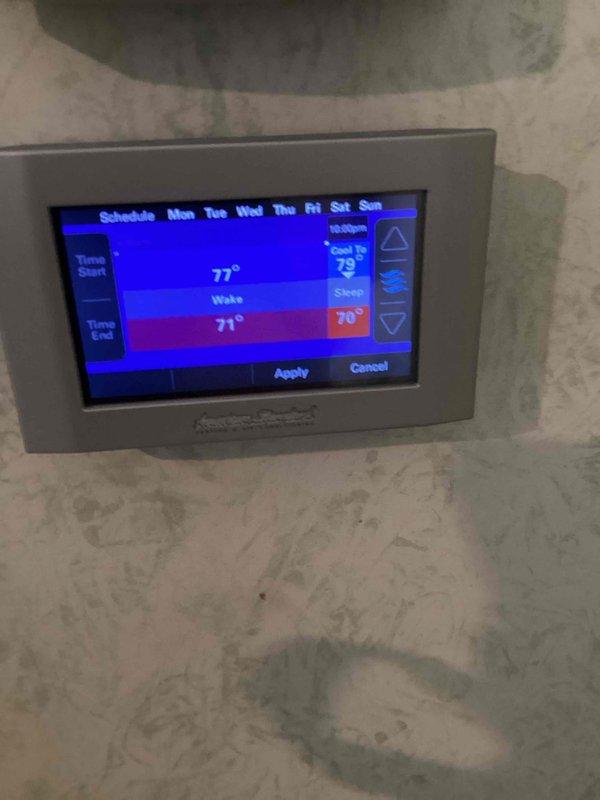 Responded to customer complaint of thermostat not maintaining set temperature, with unit cooling below the 79-degree setpoint to 73 degrees overnight. Upon inspection, found programmable thermostat with incorrect schedule settings showing wake temperature of 77 degrees and sleep mode programmed to 70 degrees, causing unintended temperature drops during nighttime hours. Reprogrammed thermostat schedule to match customer's desired comfort settings and updated system parameters to maintain consistent 79-degree setpoint throughout all time periods.