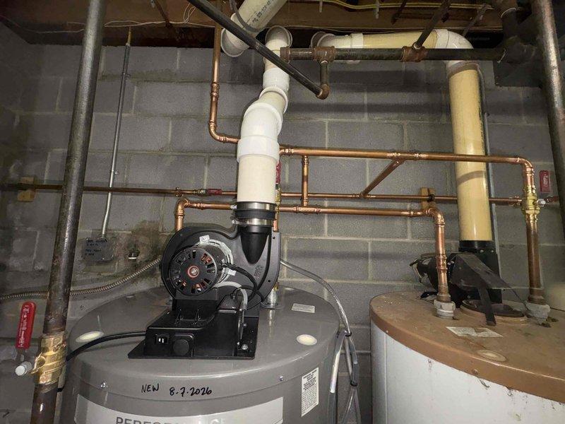 Installed customer-supplied water heater and properly repiped both water heaters with new copper piping and brass fittings to ensure proper water distribution throughout the system. Added thermal expansion tank to protect against pressure buildup, then removed and hauled away the old corroded water heater, leaving the utility area clean with all packaging materials properly disposed of.