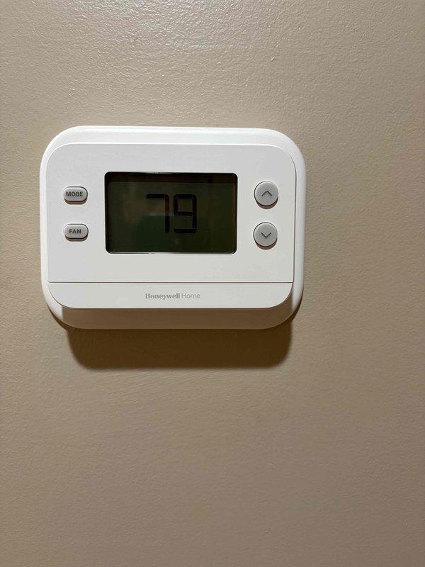 Replaced existing thermostat with new Honeywell Home non-programmable digital thermostat. Ensured proper wire termination at terminal block and verified all HVAC system connections. Positioned new thermostat to cover wall opening left by previous unit as requested.