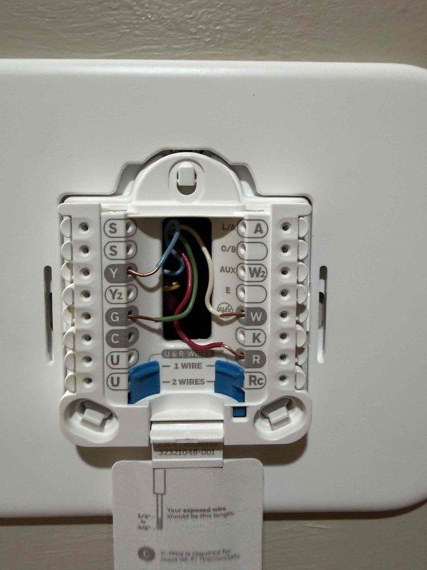 Replaced existing thermostat with new Honeywell Home non-programmable digital thermostat. Ensured proper wire termination at terminal block and verified all HVAC system connections. Positioned new thermostat to cover wall opening left by previous unit as requested.