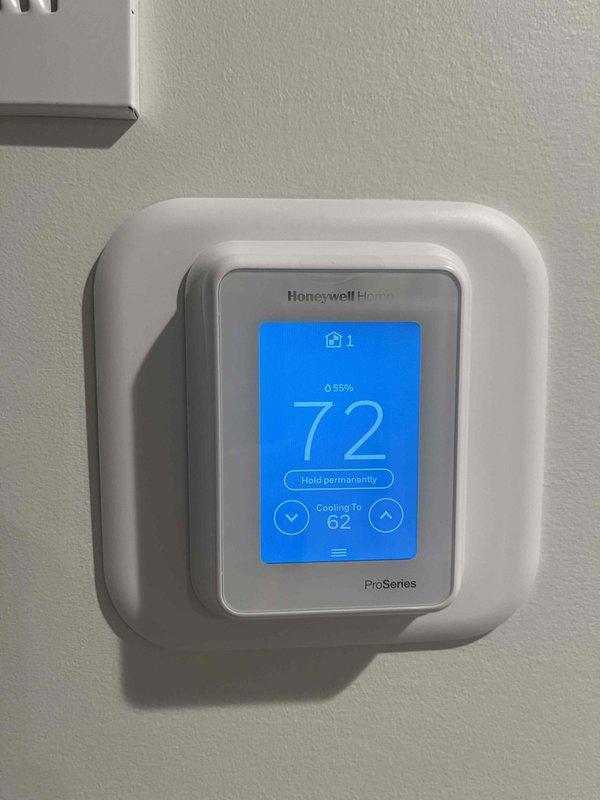 Responded to emergency no-cool call on three-month-old system that failed to operate following power outage. Upon arrival, found Honeywell Home ProSeries thermostat displaying but system unresponsive. Investigated electrical supply and control circuits, traced issue to tripped breaker or safety lockout following power disruption. Reset system controls, verified thermostat communication with air handler, and confirmed cooling operation restored with supply air temperature reading 51.6°F at ductwork. System returned to normal operation with thermostat commanding cooling cycle and maintaining setpoint.